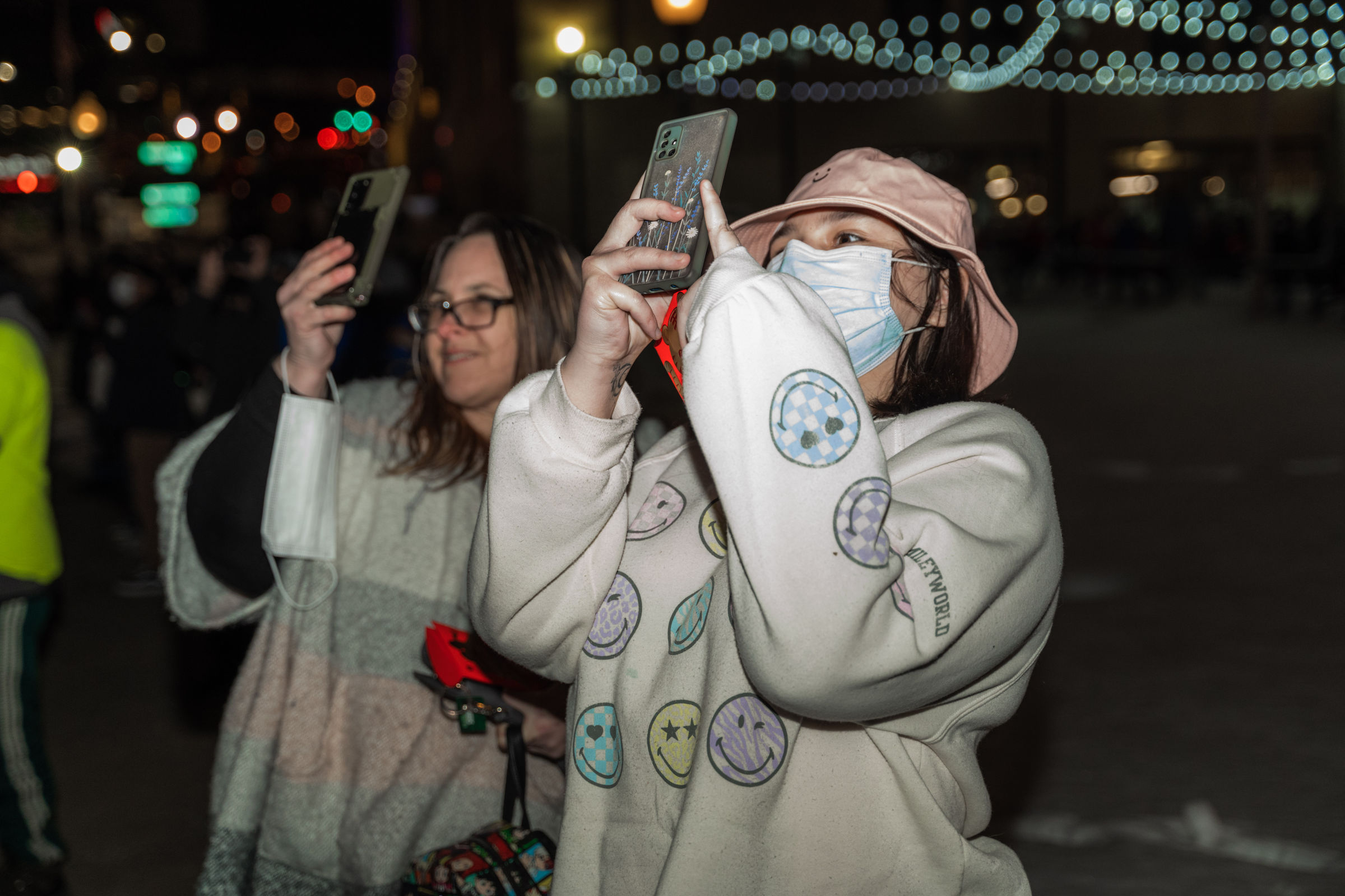 People outdoors at Lock 3 Park recording videos on smartphones